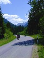 motorcyclist on the road near the forest