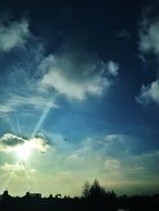 bright blinding sun in a cloudy sky
