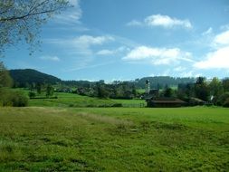 tower and house on a green meadow