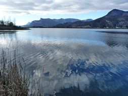 reflection of clouds in ripples of a lake