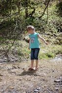 child playing in the forest