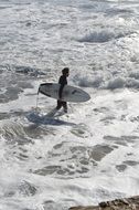 Surfer in the foam of the ocean
