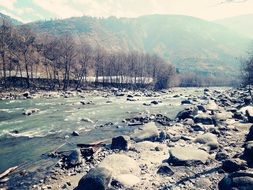river with stones near the hill