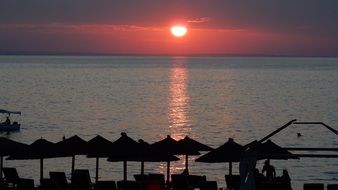 red setting sun over the coast of greece