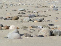 grey stones on sand beach