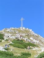 A metal cross on top of a mountain