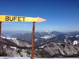 yellow sign with an arrow on a mountain in switzerland