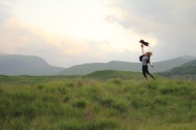 girl among the mountain summer landscape