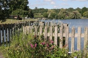 wooden fence by the lake in england on a sunny day