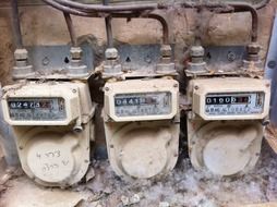 three old gas meters