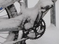 chain and bicycle wheel in snow