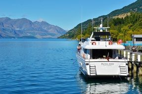 small ship near the pier on a picturesque lake