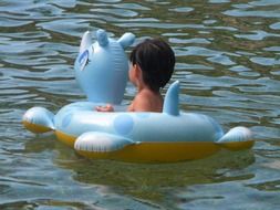 baby swimming in hot pool