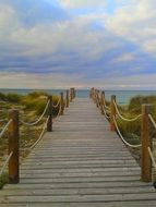 landscape of wooden pier goes to the calm sea