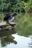 Girl looking at reflection on a lake