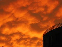 bright orange sunset in the clouds at dusk