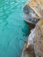 rock and blue water in nature