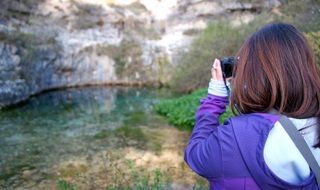 girl photographing a blue pit