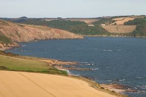 Beautiful lake between the green and yellow hills in Cornwall, England