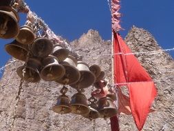 bells and a red flag on the background of the mountain