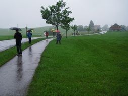 people walk in the park in the rain at Mittelberg