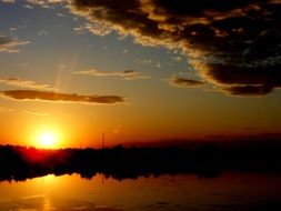 reflection in the water of the landscape at sunset
