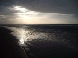sunrise behind the clouds on the ocean