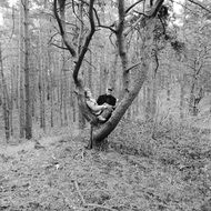 black and white photo of a child with his father in the forest