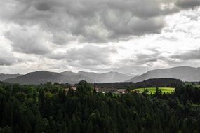 grey clouds over alpine mountains in autumn