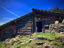 wooden alpine hut on the mountain on a sunny day