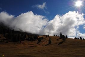 white big clouds over the mountains on a sunny day