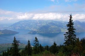 distant view of the lake on a background of mountains in the clouds in Switzerland