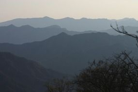 silhouettes of mountains in the fog