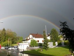 rainbow over the village in bright sunshine