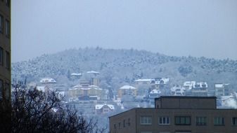 suburban houses on mountain side at snowy winter, hungary, budapest