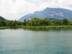 calm lake with forested shore at mountain, france