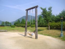 wooden swing with children scene