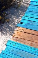colorful wooden path on a sandy beach