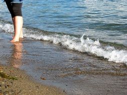 feet on the sand in the lake for relaxation