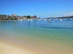 boats in ocean bay with clear water