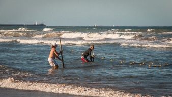 fishermen on the summer coast