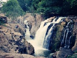 waterfalls cascade on rock river scene