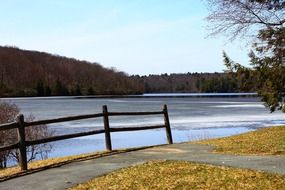 landscape of trail near the wooden fence near the lake