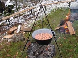 fireplace with sausage boiling outdoor camping