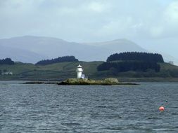 lonely lighthouse on an island in scotland