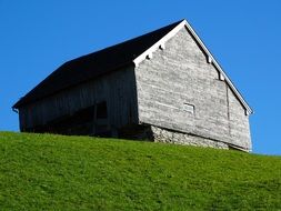 wooden barn on top of a hill