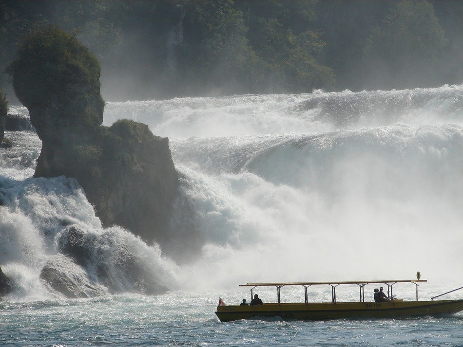 Boat near the waterfall in Switzerland