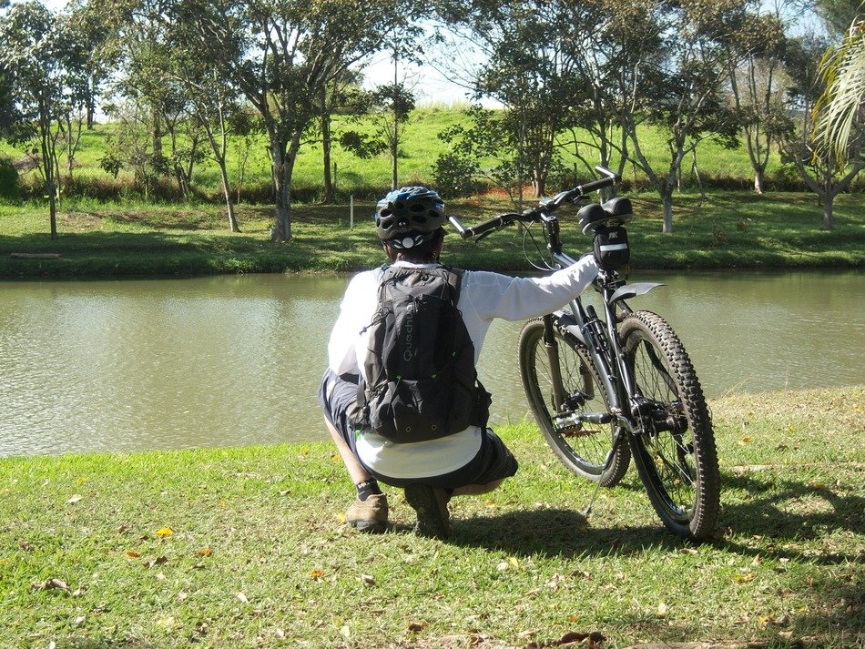 cyclist sitting by the river