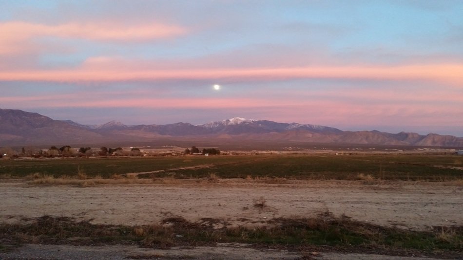 sunset behind the clouds over the desert
