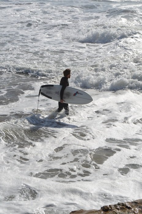 Surfer in the foam of the ocean